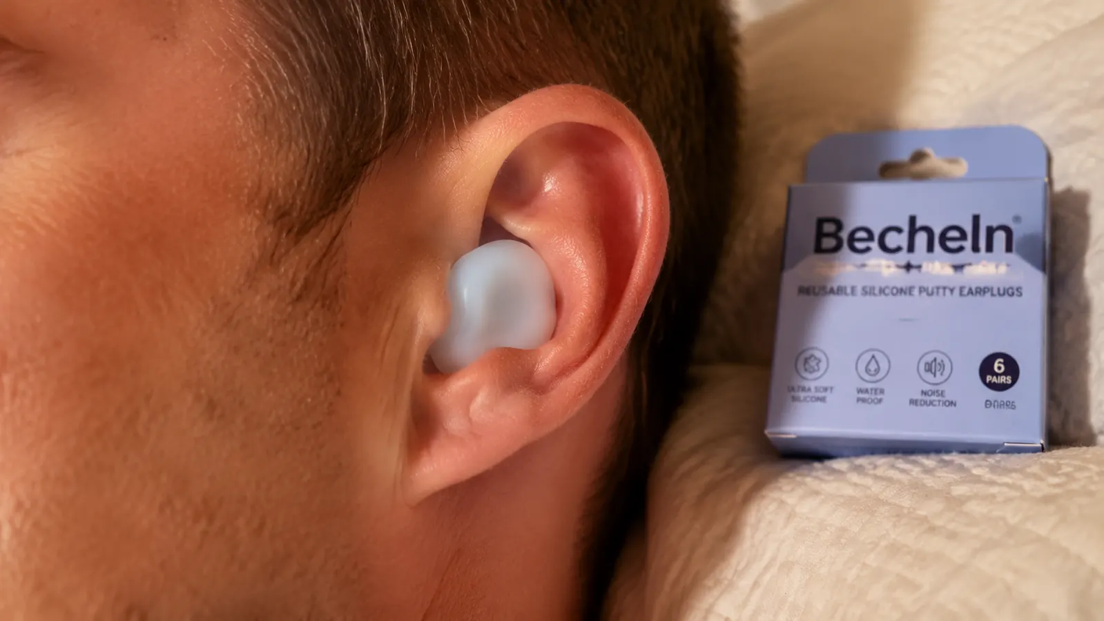 Silicone earplug pressed flush against the outer ear forming a full seal